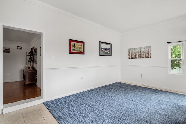 tiled empty room featuring ornamental molding