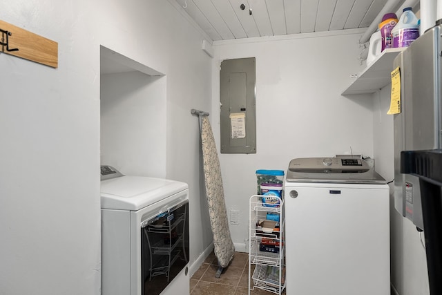 laundry room with dark tile flooring and separate washer and dryer