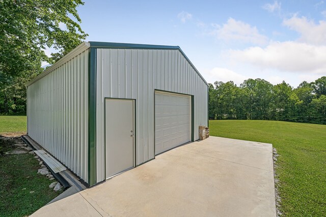 view of shed / structure featuring a yard and a garage