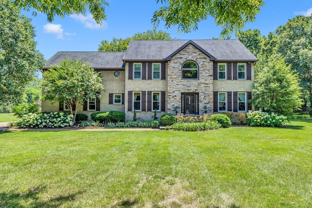 colonial inspired home featuring a front lawn