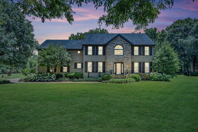 colonial-style house featuring a yard