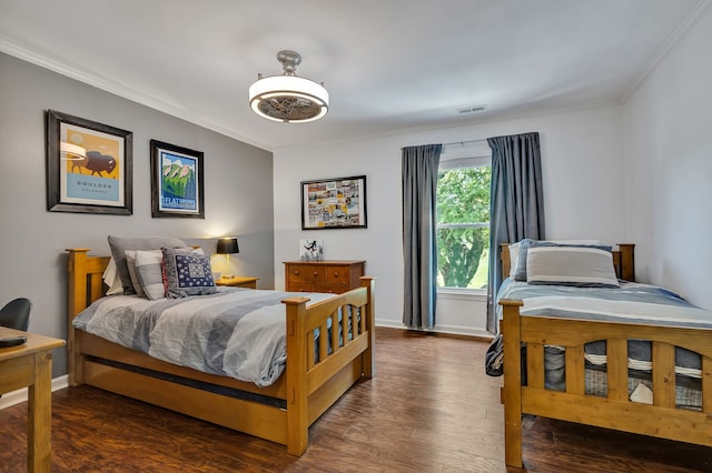 bedroom with dark hardwood / wood-style flooring and crown molding