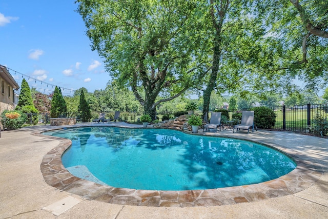 view of swimming pool featuring a patio area