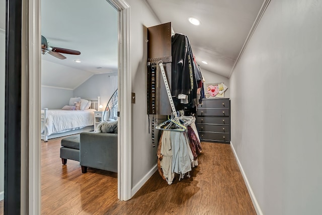 interior space featuring lofted ceiling, crown molding, and dark hardwood / wood-style flooring