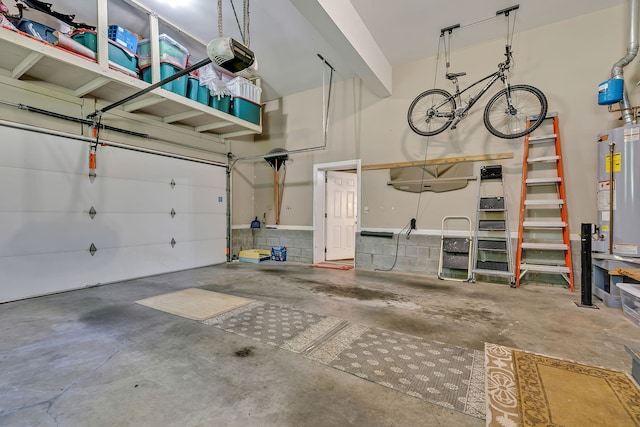 garage with water heater and a garage door opener