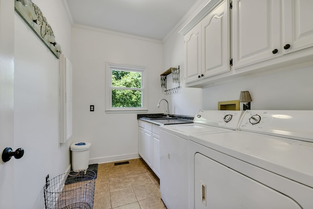 laundry area featuring cabinets, light tile flooring, ornamental molding, and washing machine and dryer