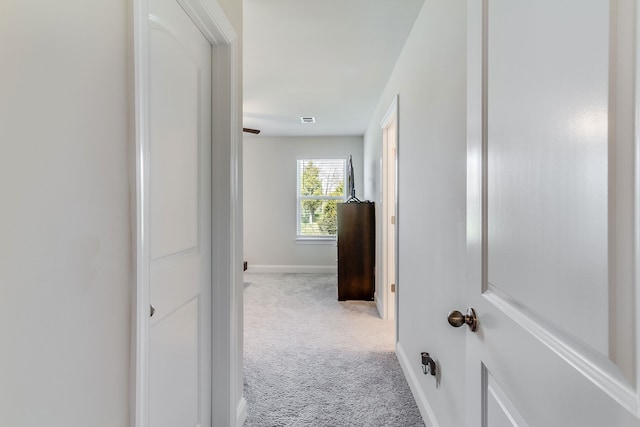 hallway featuring light carpet