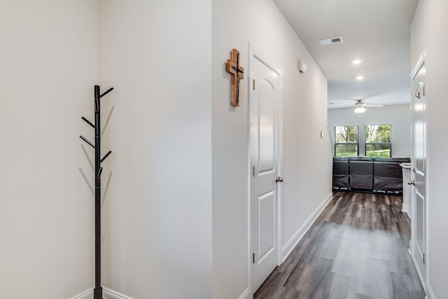 hallway with dark hardwood / wood-style flooring