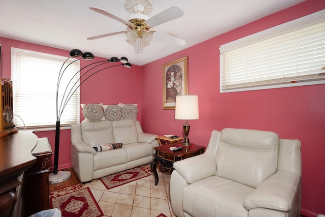 tiled living room with ceiling fan