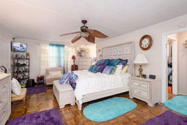 bedroom with parquet flooring, ceiling fan, and a textured ceiling