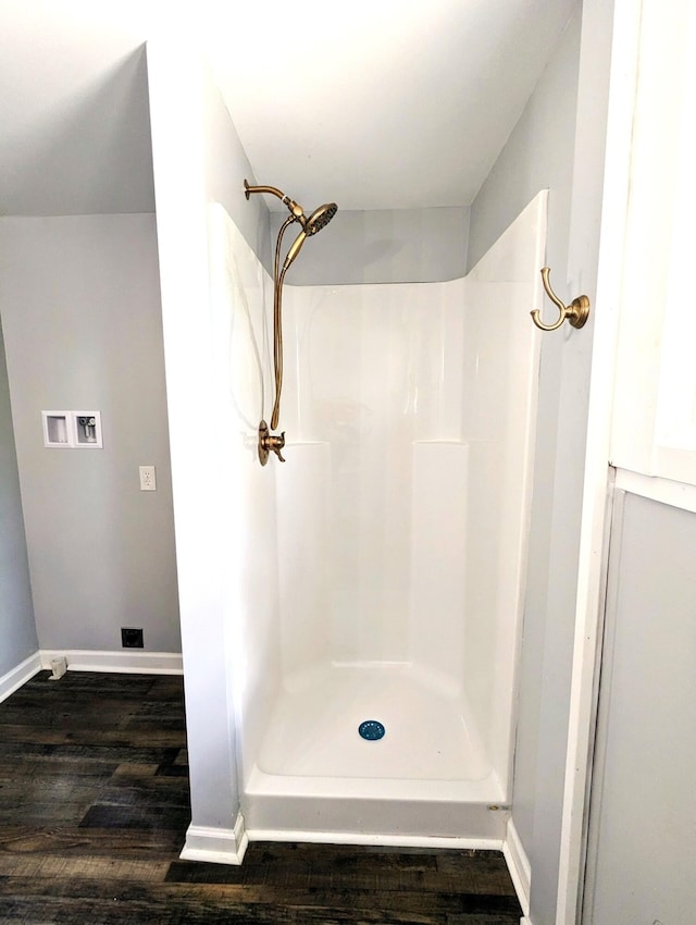 bathroom featuring a shower and hardwood / wood-style floors