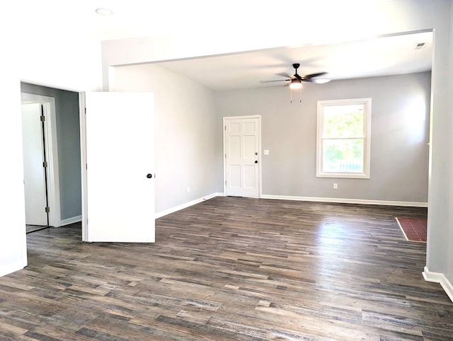 empty room featuring ceiling fan and dark wood-type flooring