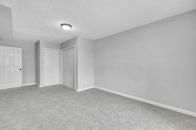 interior space featuring carpet and a textured ceiling