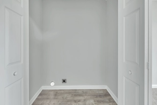 washroom featuring electric dryer hookup and dark wood-type flooring