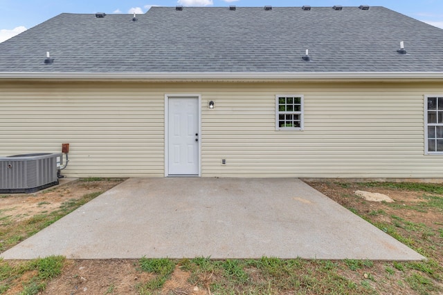 back of house featuring central air condition unit and a patio area