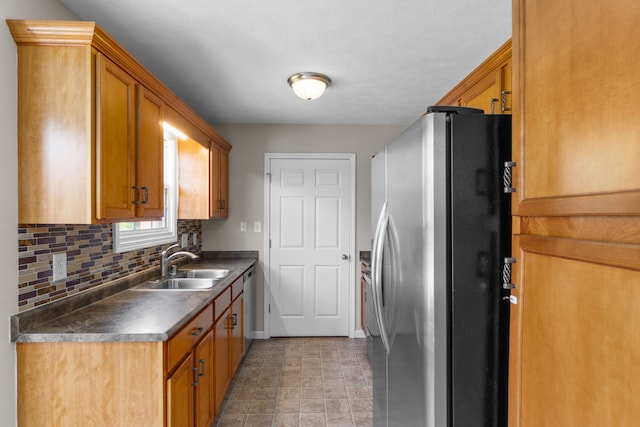 kitchen featuring tasteful backsplash, sink, light tile floors, and stainless steel appliances