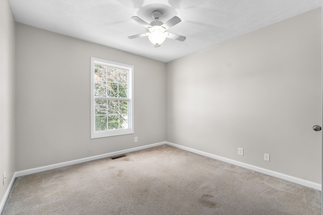 carpeted empty room with ceiling fan