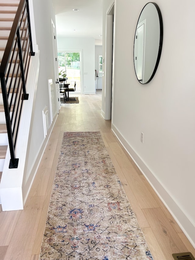 hall with light hardwood / wood-style flooring