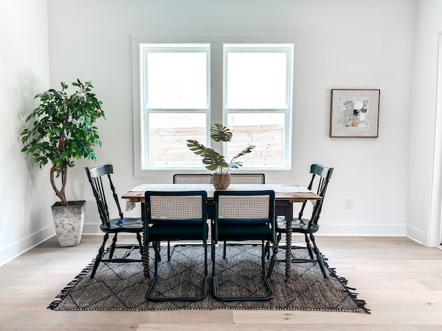 dining space with light hardwood / wood-style floors