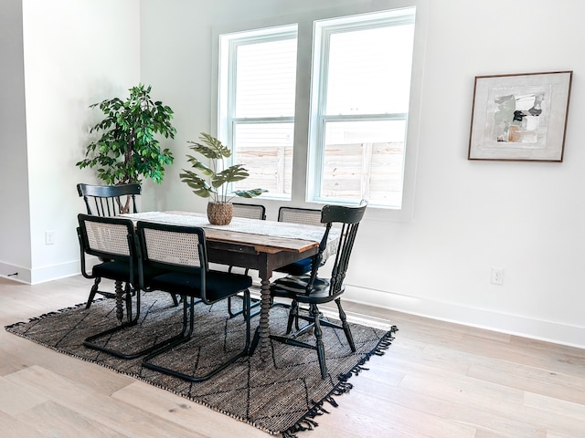 dining space featuring a wealth of natural light and light wood-type flooring