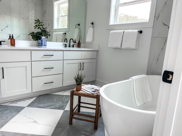 bathroom featuring tile floors, double vanity, and a bath