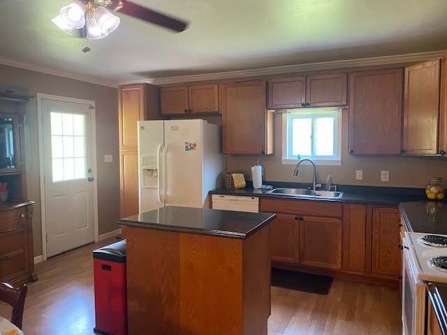 kitchen featuring white appliances, a center island, ceiling fan, and light hardwood / wood-style flooring