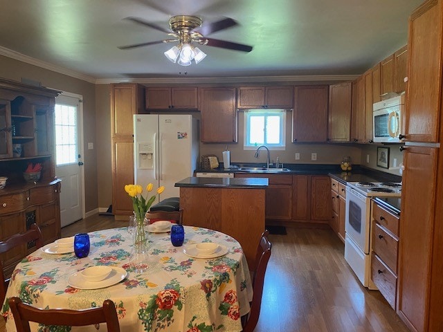 kitchen with a kitchen island, ceiling fan, white appliances, dark hardwood / wood-style flooring, and sink