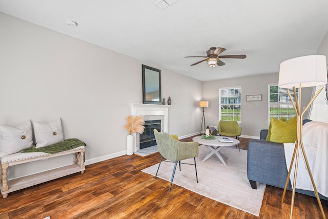 living room with dark hardwood / wood-style flooring and ceiling fan