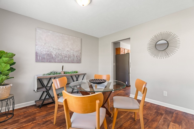 dining room with dark hardwood / wood-style flooring