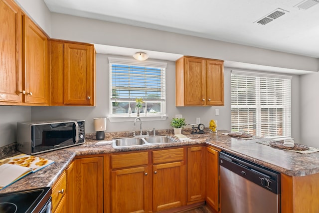 kitchen featuring stainless steel appliances, kitchen peninsula, and sink