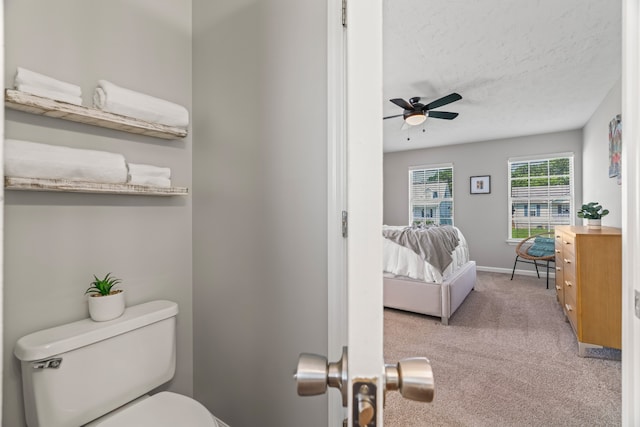 bathroom featuring vanity, a textured ceiling, ceiling fan, and toilet