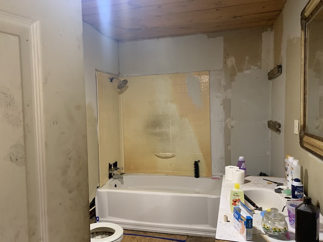 bathroom with toilet, tiled shower / bath combo, and wood ceiling