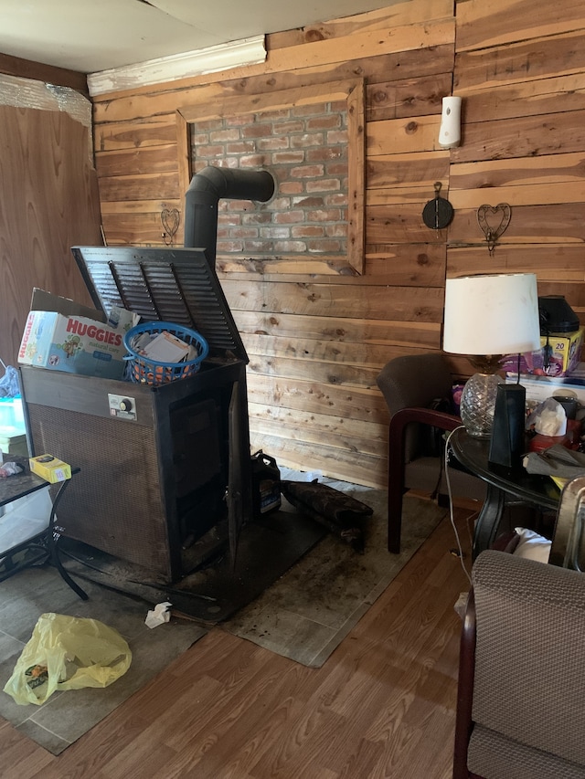 interior space with wood walls, dark hardwood / wood-style floors, and a wood stove