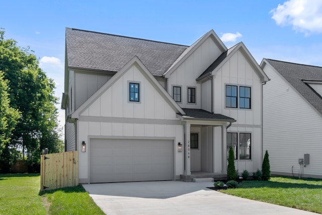 view of front of property with a front lawn and a garage