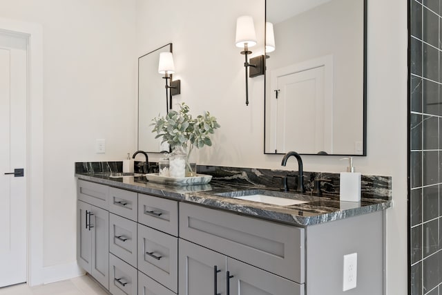 bathroom featuring tile flooring, double sink, and oversized vanity