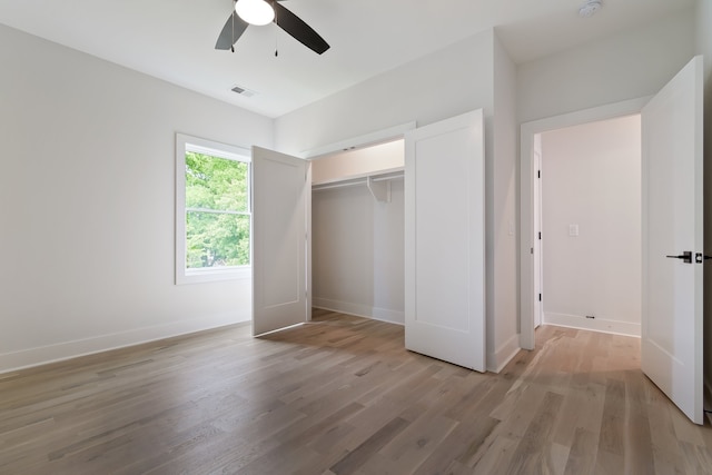 unfurnished bedroom with a closet, ceiling fan, and light hardwood / wood-style flooring