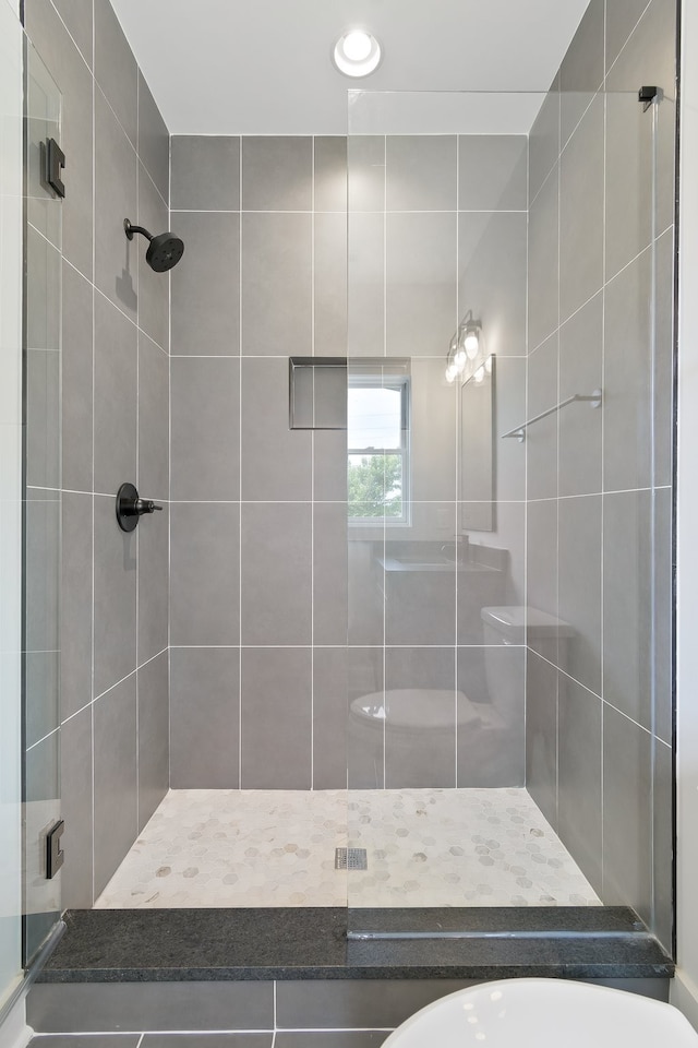 bathroom with tiled shower