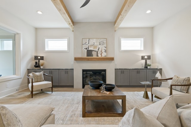 living room featuring a wealth of natural light and beamed ceiling