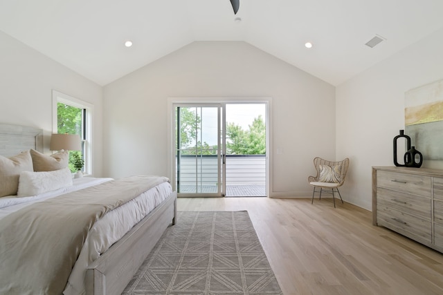 bedroom featuring access to exterior, vaulted ceiling, light hardwood / wood-style floors, and multiple windows