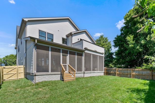 back of property with a yard and a sunroom