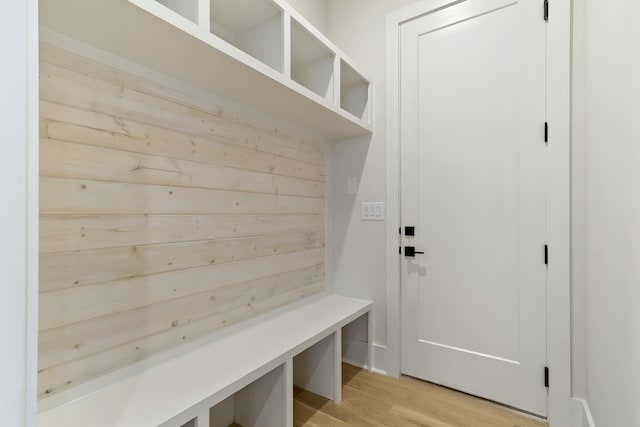 mudroom featuring wooden walls and light wood-type flooring