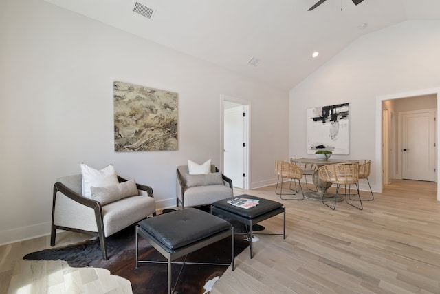 sitting room with ceiling fan, vaulted ceiling, and light hardwood / wood-style floors