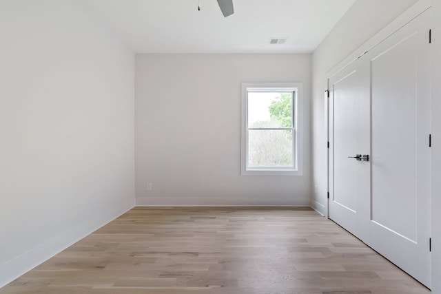 spare room featuring light hardwood / wood-style floors and ceiling fan