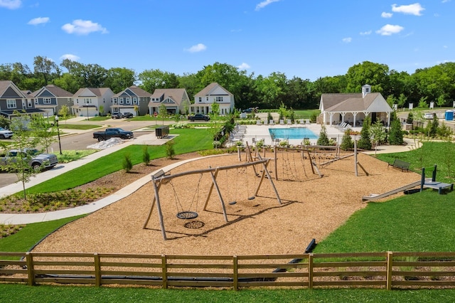 view of nearby features with a pool, a yard, and a playground