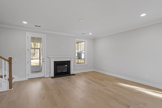 unfurnished living room with plenty of natural light, light hardwood / wood-style floors, and ornamental molding