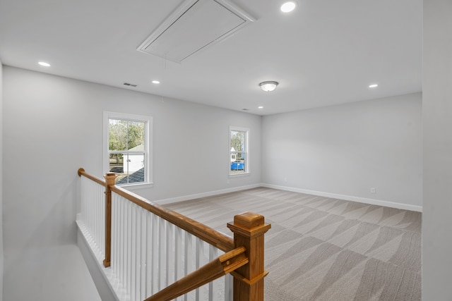 empty room with light colored carpet and a wealth of natural light