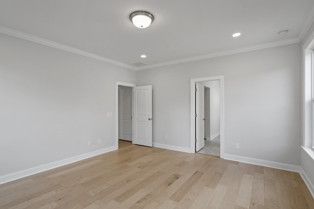 empty room with light wood-type flooring and ornamental molding