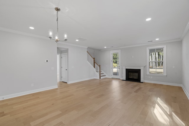 unfurnished living room with a notable chandelier, light hardwood / wood-style flooring, and crown molding