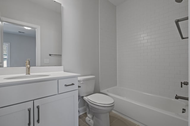 full bathroom with tile floors, toilet, vanity, and tiled shower / bath