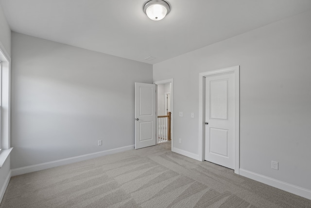 unfurnished room with light carpet